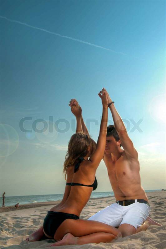 Happy couple enjoying vacations on the beach, stock photo