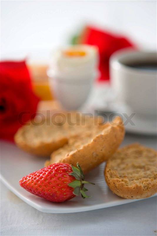 Romantic breakfast with boiled egg, toast, coffee and strawberry, stock photo