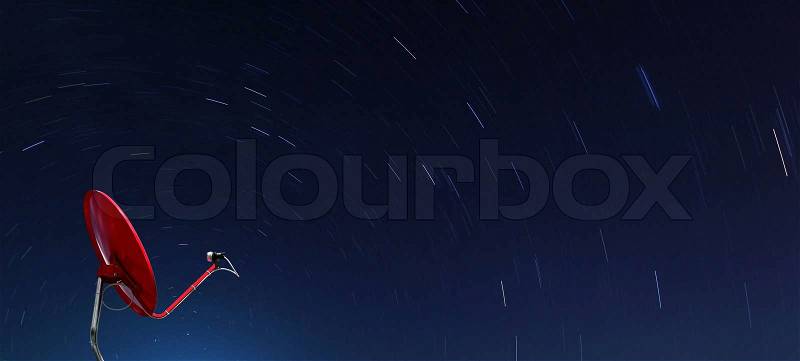 Conceptual of Red satellite over spiral star at night, stock photo