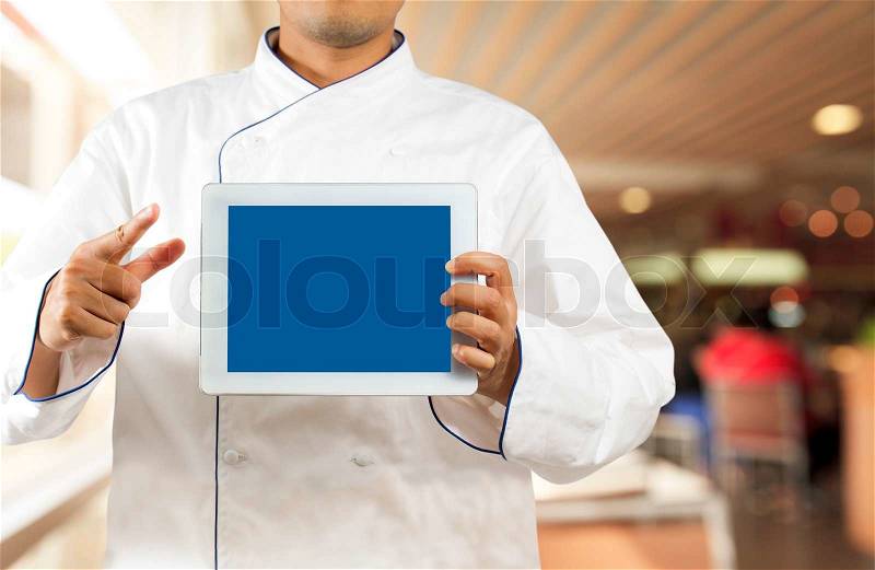 Chef showing a digital tablet, stock photo