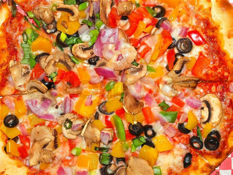 A Fresh and Healthy Vegetable Pizza on Red Checked Paper, stock photo