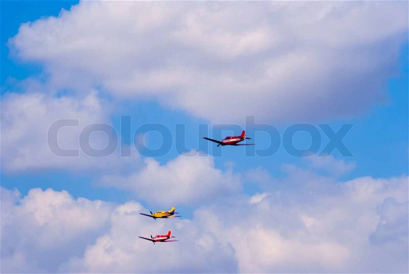 Formation flying light training and commercial aircraft, stock photo