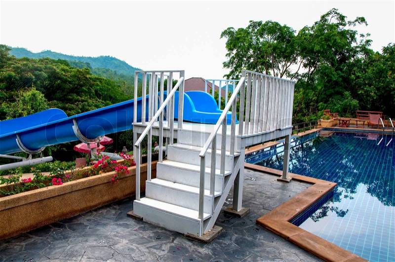 The Wooden staircase to water slide tube to the pool, stock photo