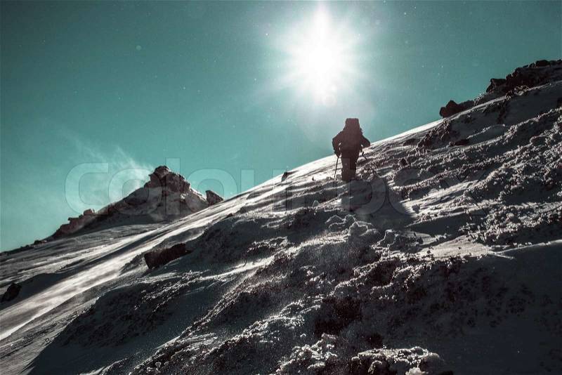 Climber climbing on an icy hill, stock photo