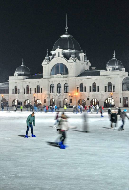 BUDAPEST - DECEMBER 13:Ice skaters in City Park Ice Rink on December 13, 2012 in Budapest, Hungary Opened in 1870, it is the largest and one of the oldest ice rinks in Europe, stock photo