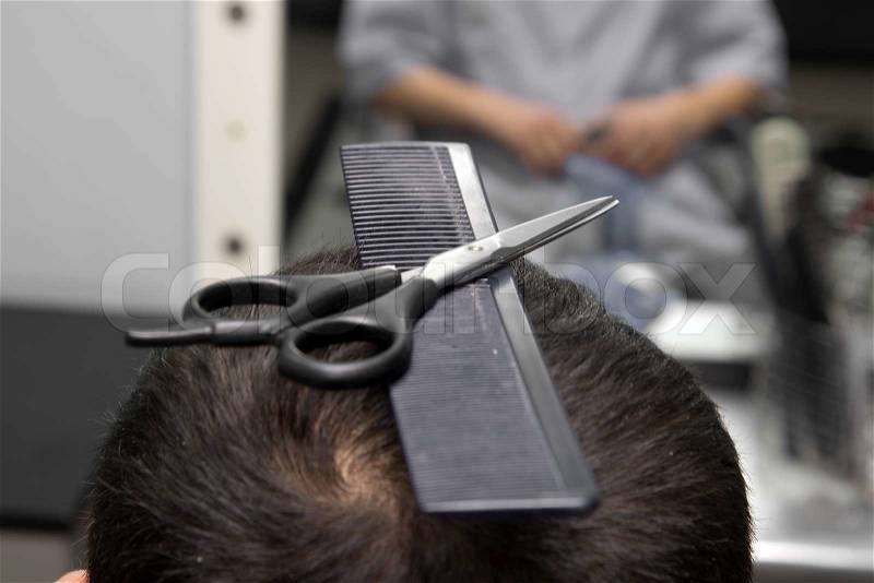 Scissors with a comb in the hair salon, stock photo
