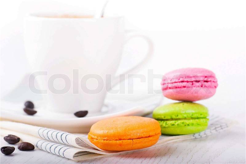 Multi-colored cakes and coffee on a white napkin, stock photo