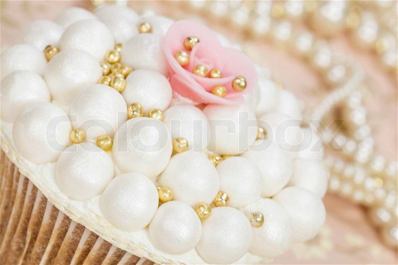 Wedding cupcake and pearls in background, stock photo