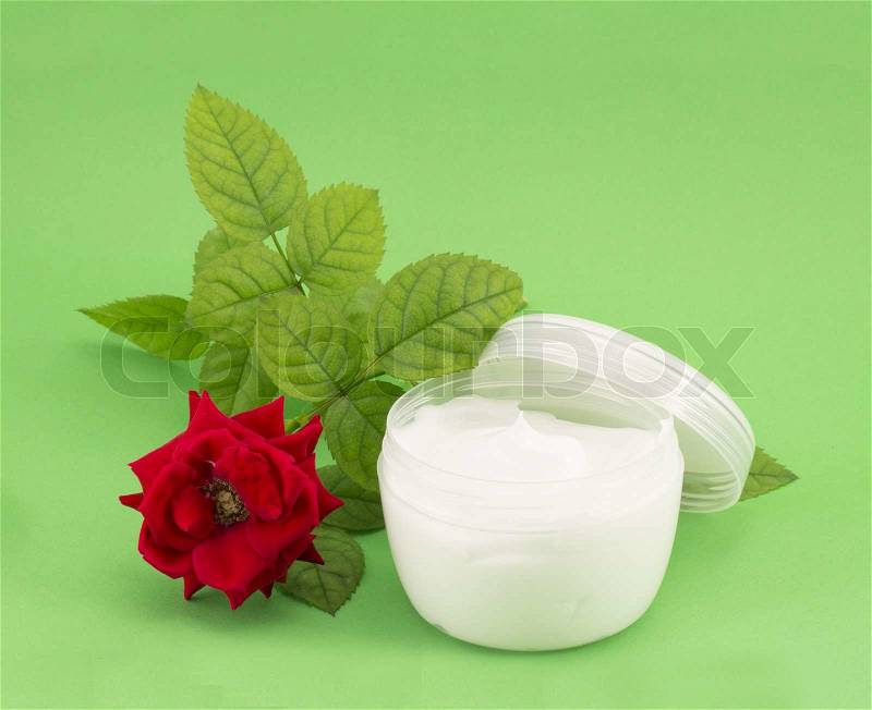 Tube of cream, white and cream roses, stock photo