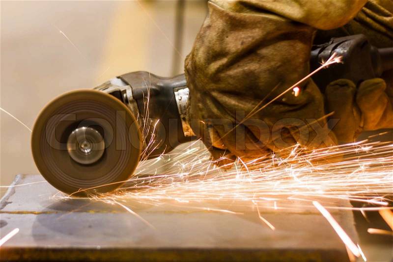 Cutting metal by electric wheel grinding, stock photo