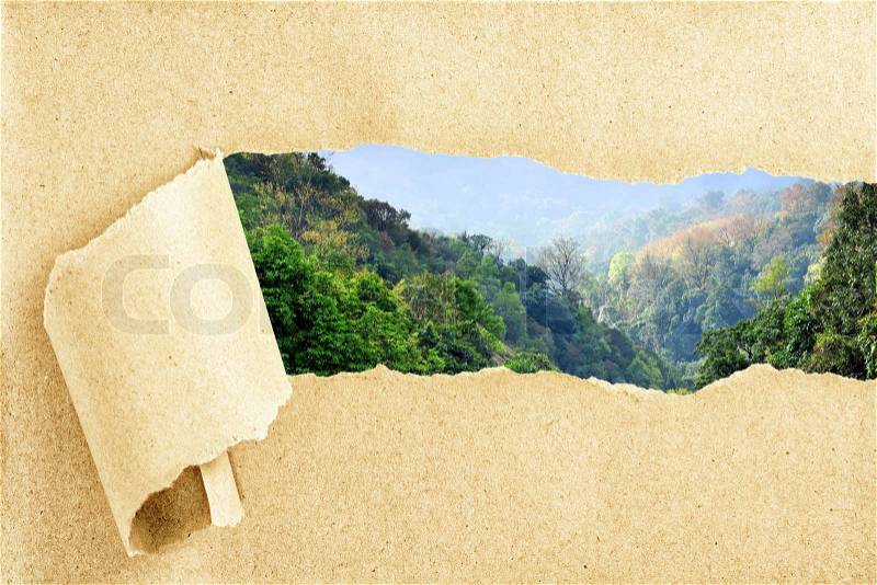 Mountain view behind torn recycled paper, stock photo