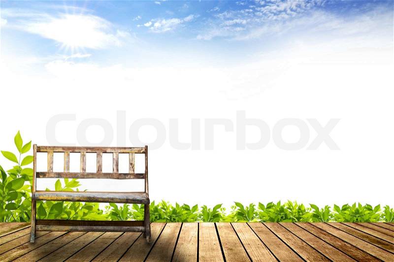 Vintage old wooden bench on wooden walk way in the garden with beautiful blue sky and sunny background, stock photo