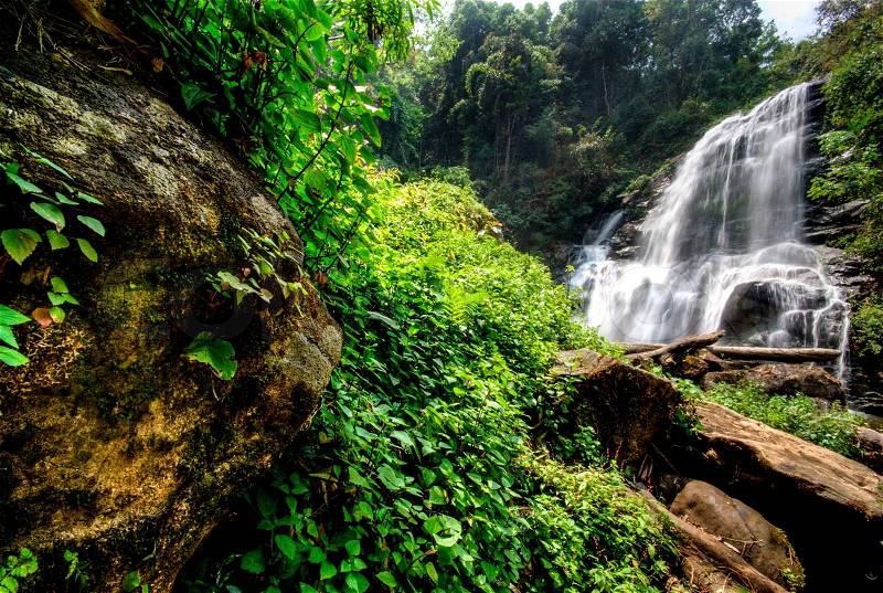 Water fall in spring season located in deep rain forest jungle Mae Klang Luang Waterfall, Chiang Mai, Thailand, stock photo