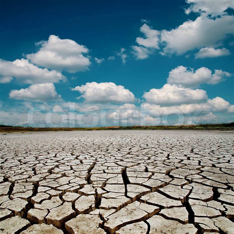 Global warming. dramatic sky over cracked earth, stock photo