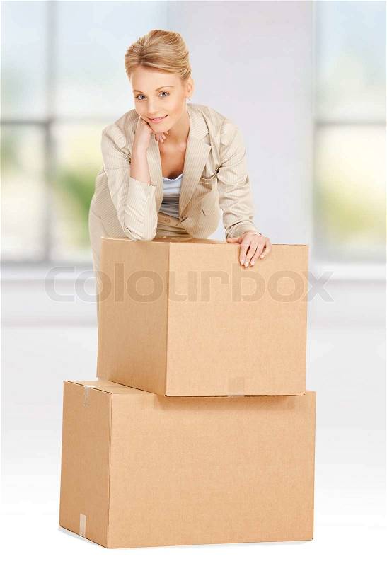 Attractive businesswoman with big boxes, stock photo
