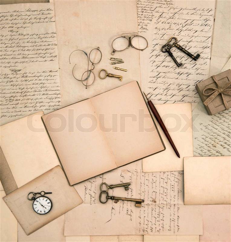 Open book, vintage accessories, old letters and documents, stock photo
