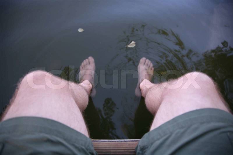 Image og man's feet in water, stock photo