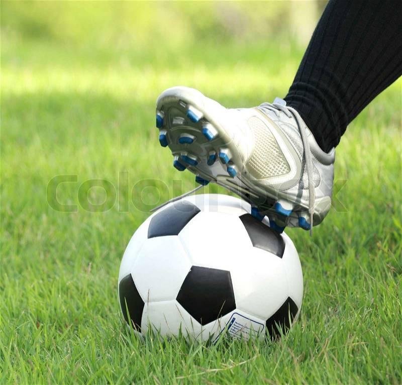 Football player, man foot on the ball, stock photo