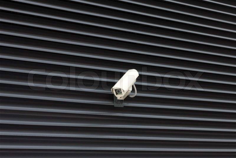 High tech overhead security camera on the metal wall, stock photo