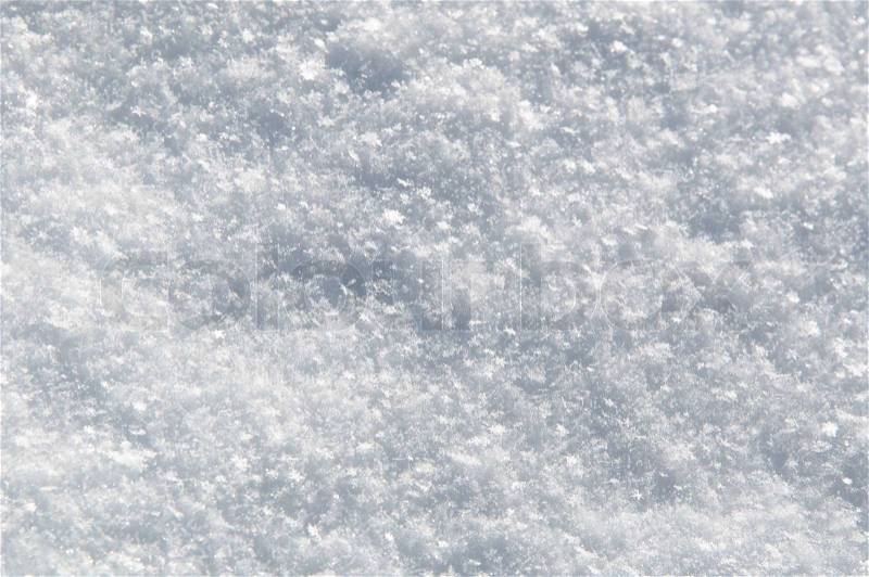 Texture of white snow sparkling in the sun on a bright winter day, stock photo