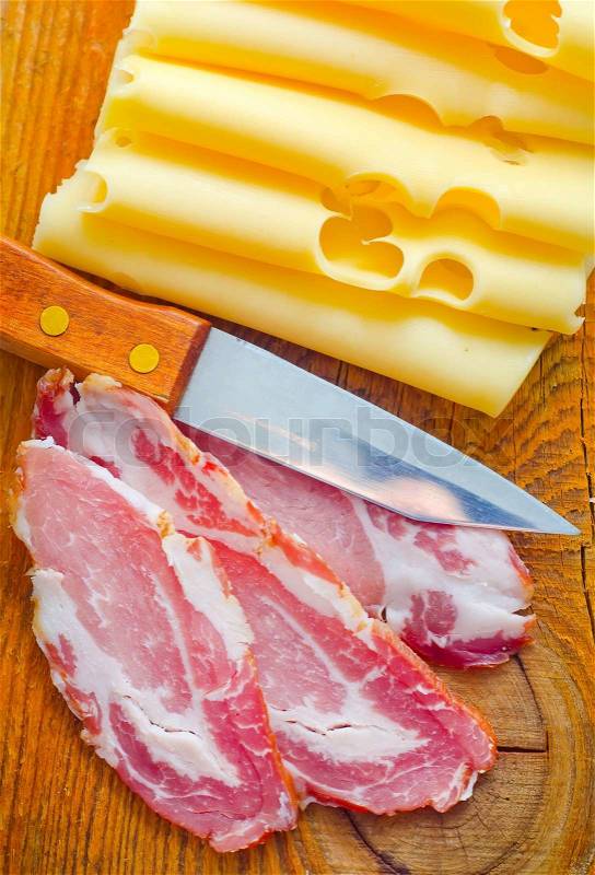 Bacon with cheese on the wooden board, stock photo