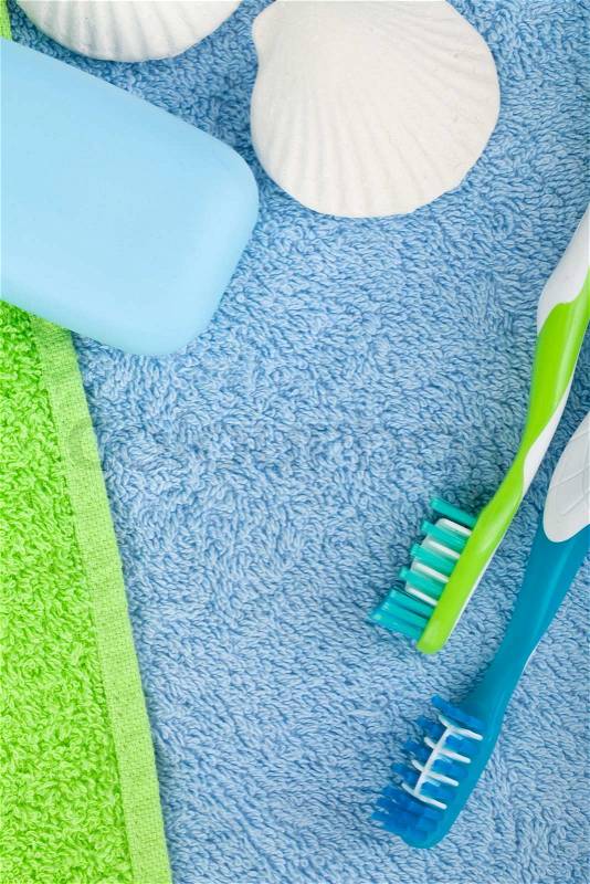 Toothbrushes and soap over towels. View from above, stock photo