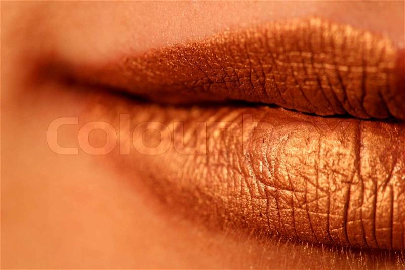 Macro blur image of bright lips -gold lipstik, stock photo