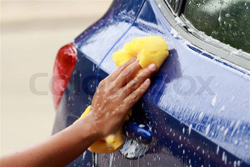 Outdoor car wash with yellow sponge, stock photo