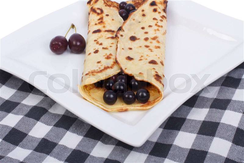 Pancakes with black currant on a tablecloth, stock photo