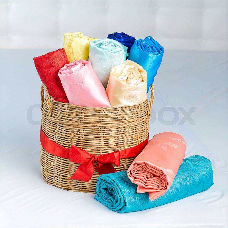 Colorful silk rolled and keep in the basket, stock photo