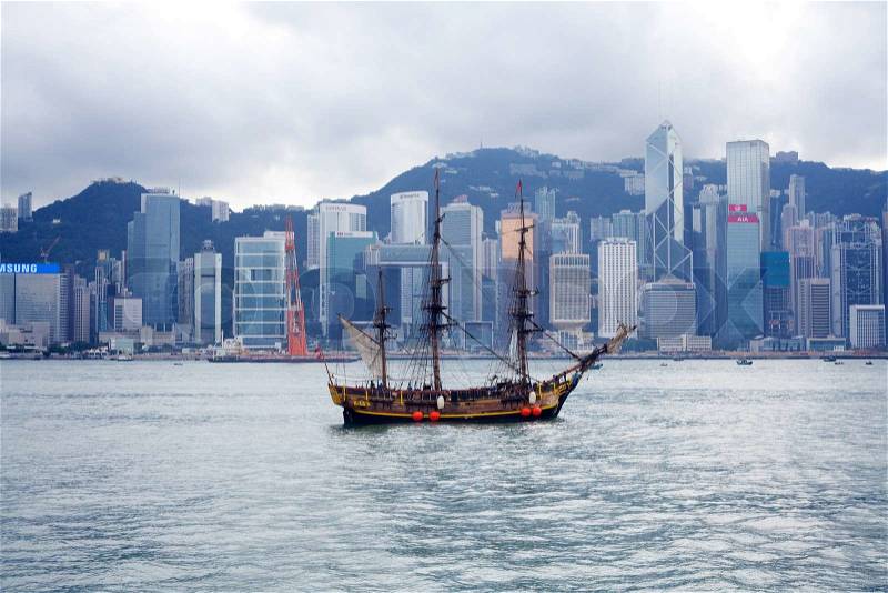 HONG KONG - NOVEMBER 20: Junk boat in bay against skyline, on November 20, 2011. Hong Kong is an international financial center, which consists of 112 buildings, standing higher than 180 meters, stock photo