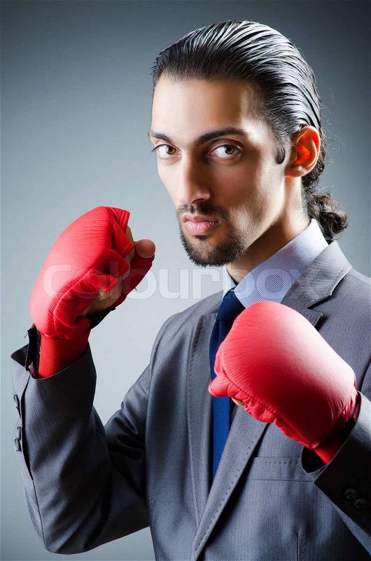 Businessman with boxing gloves on white, stock photo
