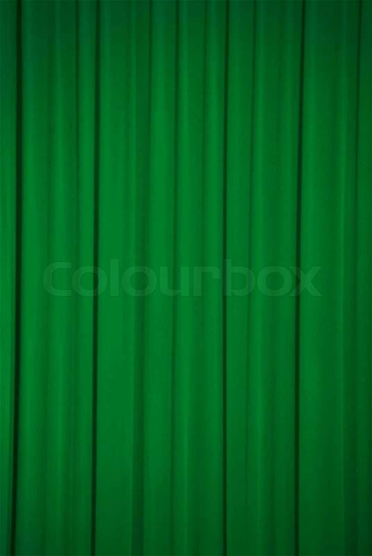 Brightly lit green curtains for background, stock photo