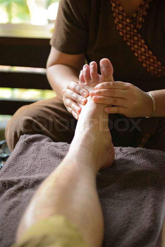 The women massage his foot for thai spa foot massage, stock photo