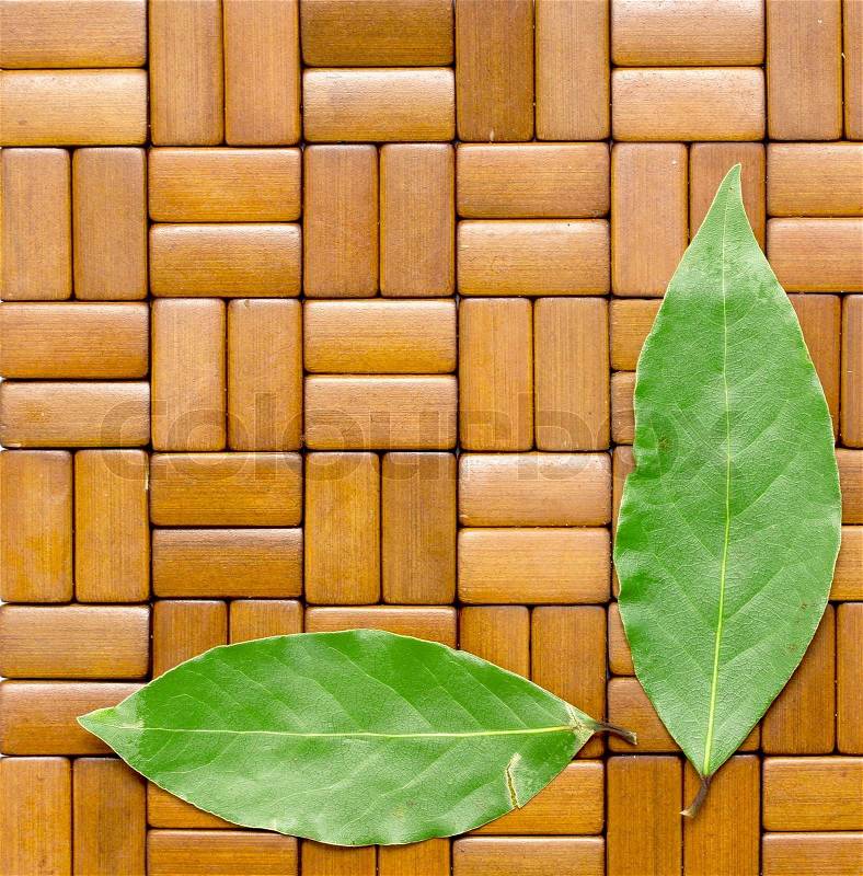 Green bay leaf on wooden background, stock photo