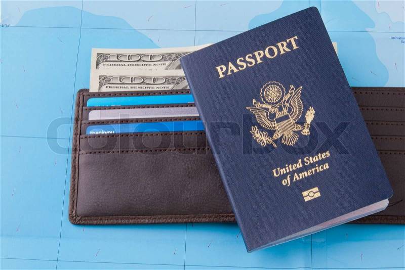 American passport and wallet with dollars cash and credit cards on map background for business travel concept. Horizontal, stock photo