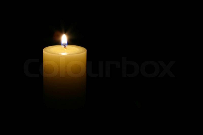 A candle isolated with black background, stock photo