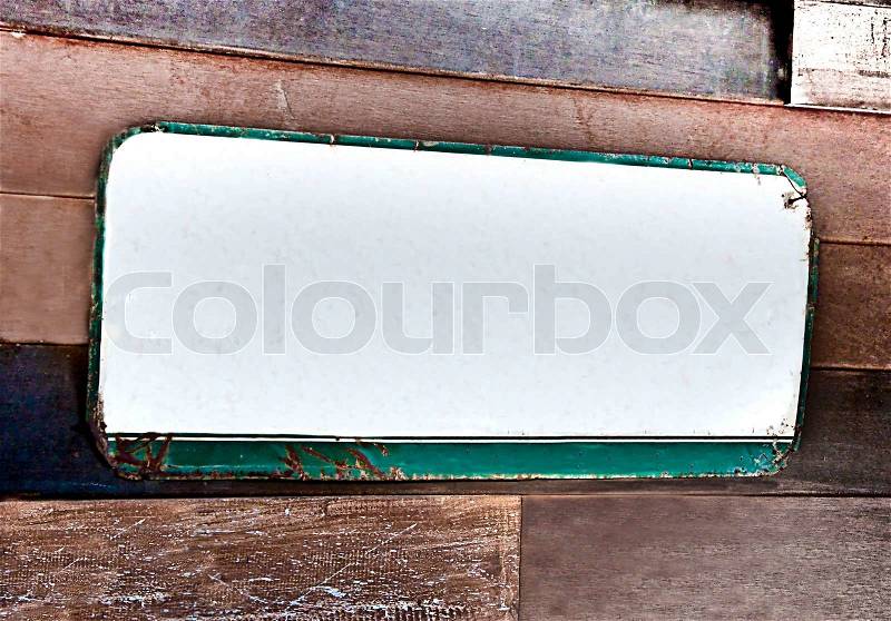 The Old metal plate frame on wood background, stock photo
