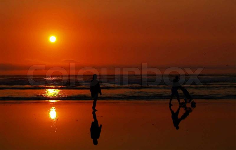 Sunset with people at the Beach on the Oregon Coast, stock photo