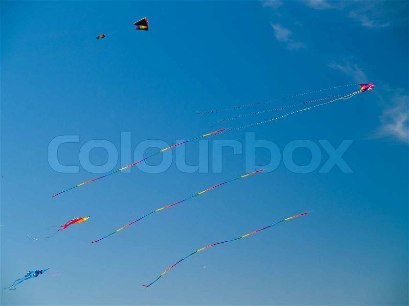 Various Colorful Kites Flying in a Bright Blue Sky at the Long Beach Kite Festival, stock photo