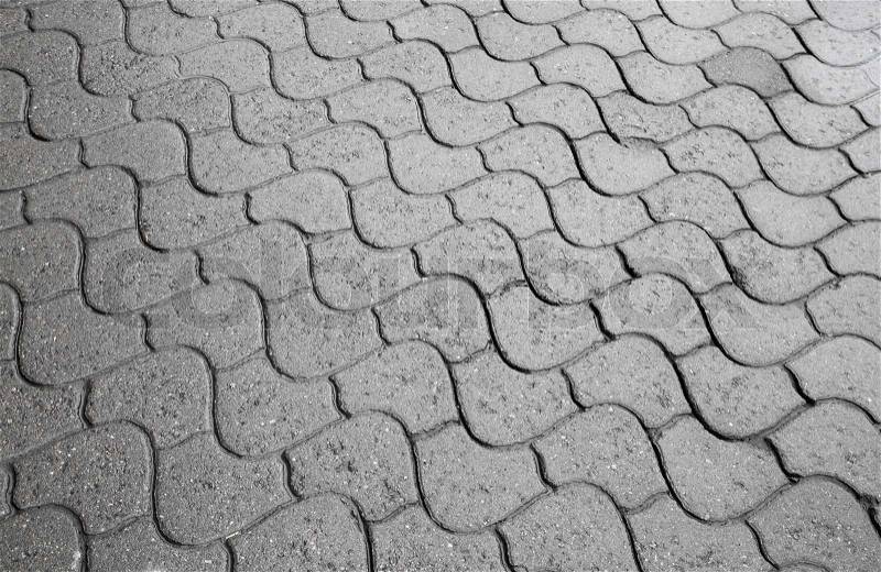 Background texture of gray city cobblestone road, stock photo