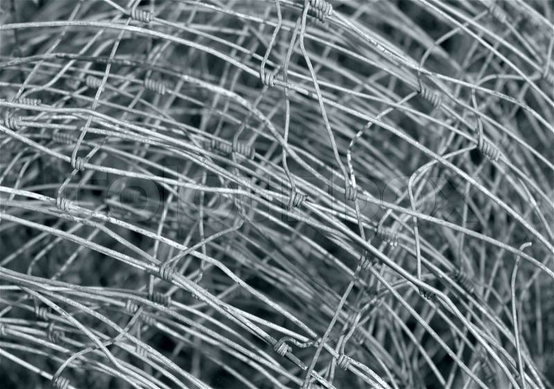 Abstract detail of a rolled mesh wire fence made of metal, stock photo