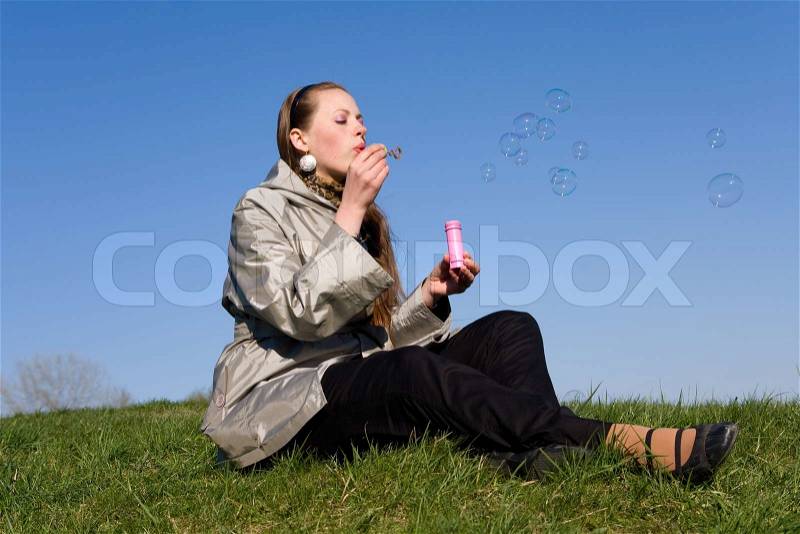 Girl makes soap bubble, stock photo