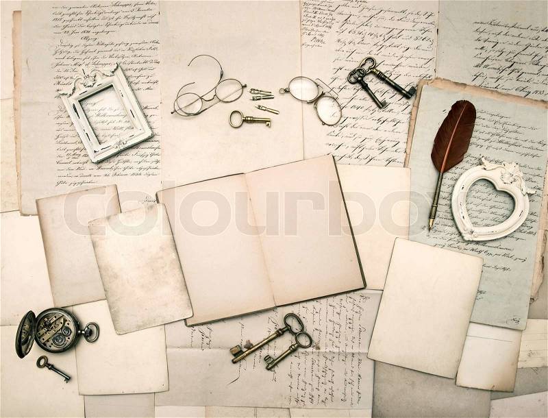 Vintage things, glasses, keys, open book, old letters and photo frames. nostalgic sentimental paper background, stock photo
