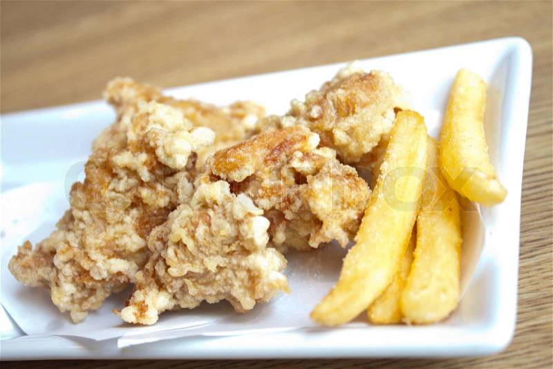 Delicious fries chicken wit french fries in plate, stock photo