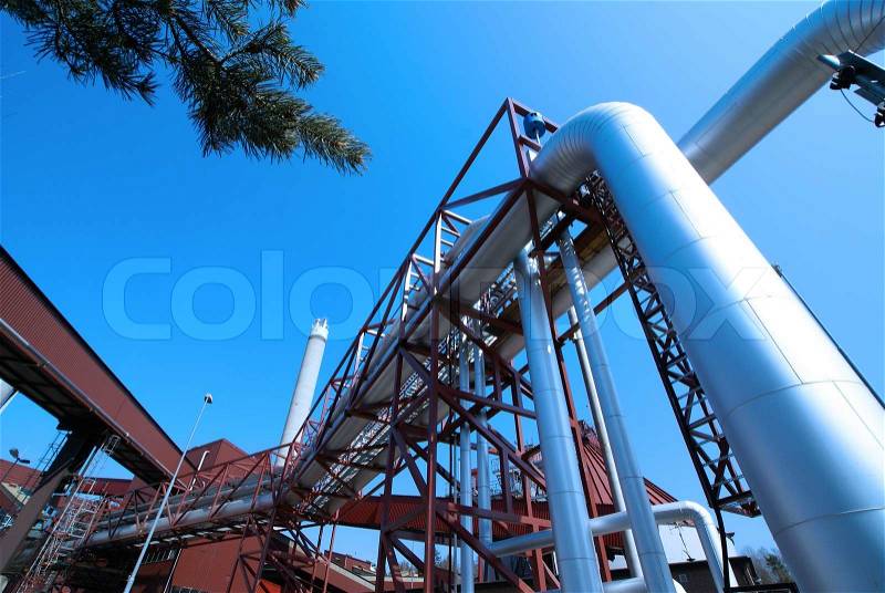 Industrial zone, installation of Steel pipelines and cables in blue tones, stock photo