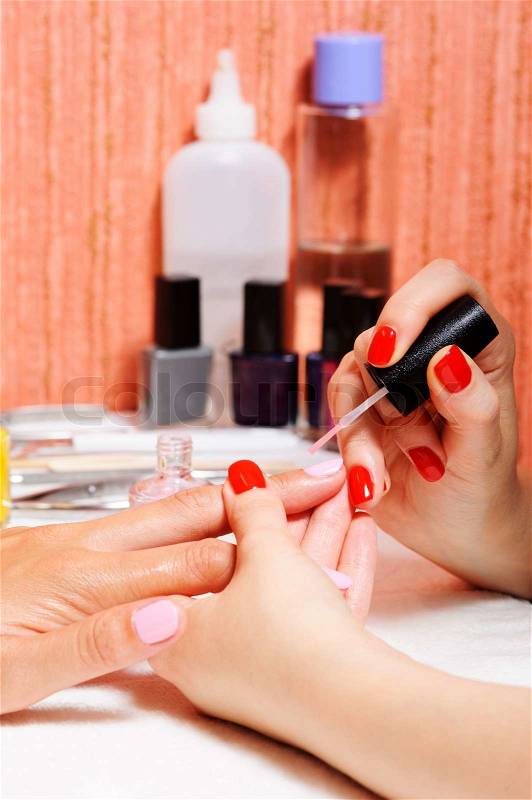Skin and nail care. Applying of the Transparent varnish. , stock photo