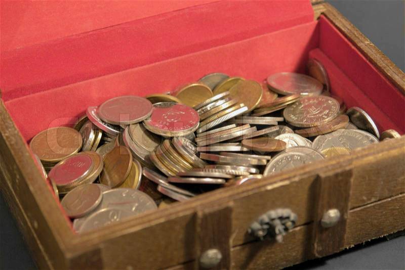 Money background with lots of coins in a treasure chest, stock photo