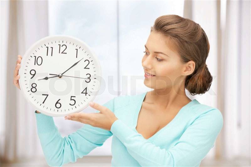 Bright picture of woman holding big clock, stock photo