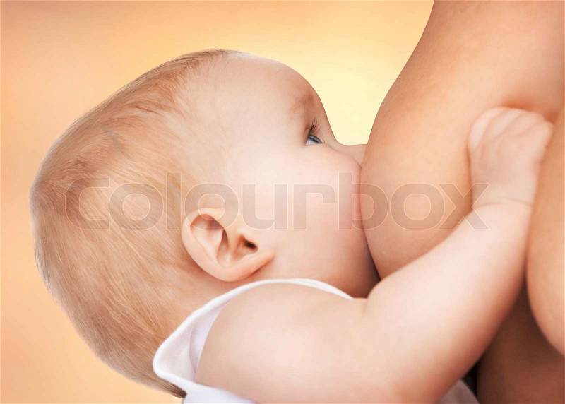 Picture of calm mother feeding adorable baby, stock photo